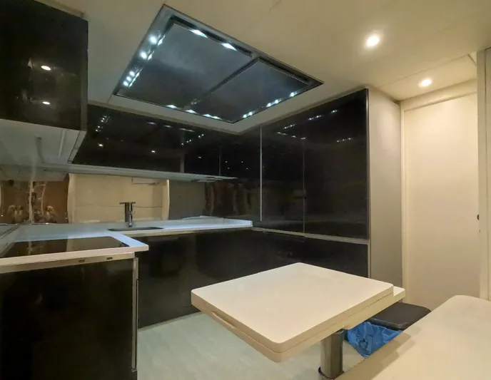  Yacht Photos Pics Modern kitchen interior on 2012 Pershing 92 yacht with sleek black cabinetry.