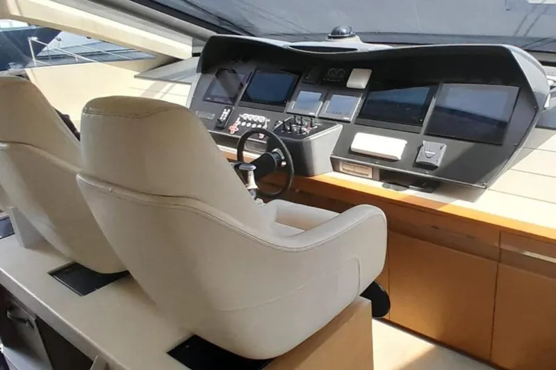  Yacht Photos Pics Interior cockpit of 2012 Pershing 92 yacht with modern navigation controls and leather seats.