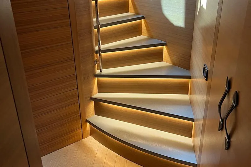  Yacht Photos Pics Luxurious wooden staircase with ambient lighting on a 2012 Pershing 92 yacht.