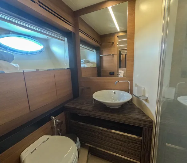  Yacht Photos Pics Luxurious bathroom in 2012 Pershing 92 yacht with modern fixtures and wood accents.