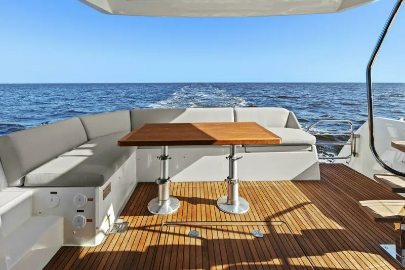 Brace Yourself Too Yacht Photos Pics Luxury 2022 Prestige 460 yacht deck with wooden table and ocean view.