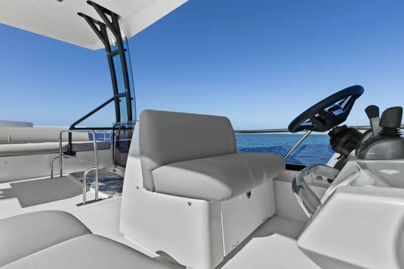 Brace Yourself Too Yacht Photos Pics Prestige 460 yacht interior, 2022 model, featuring sleek seating and steering area against a clear blue sky.