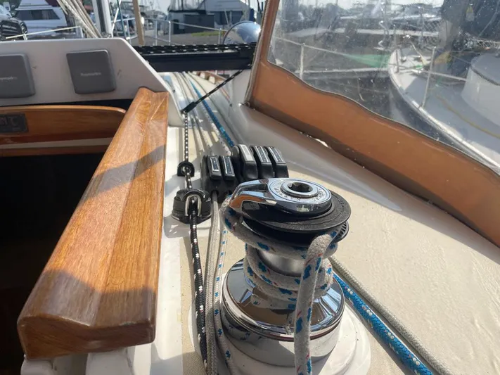 Bell Canto Yacht Photos Pics 2006 Tartan 3400 sailboat deck with winch and ropes in marina setting.