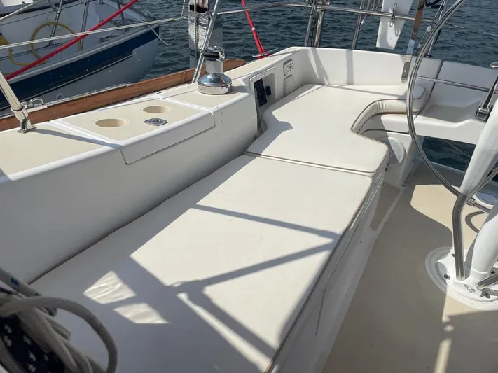 Bell Canto Yacht Photos Pics 2006 Tartan 3400 sailboat cockpit with white seating and steering wheel.