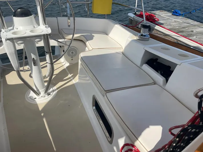 Bell Canto Yacht Photos Pics Cockpit of 2006 Tartan 3400 sailboat with white seating and steering wheel.