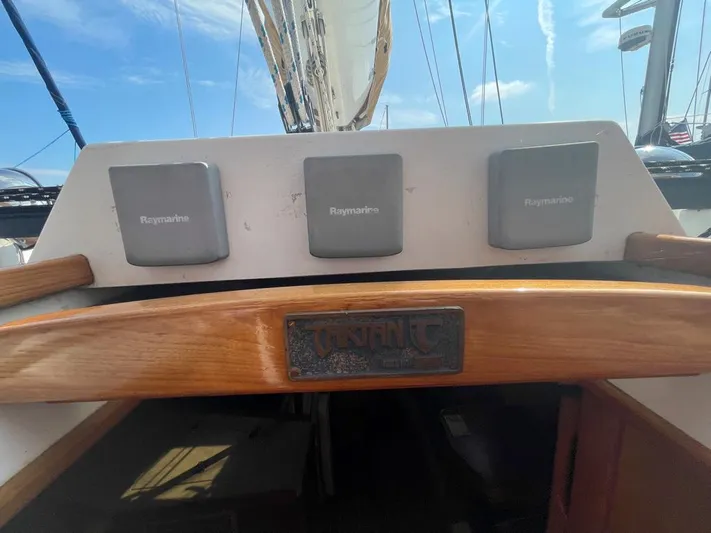 Bell Canto Yacht Photos Pics Cockpit of 2006 Tartan 3400 sailboat with Raymarine instruments and wooden trim.