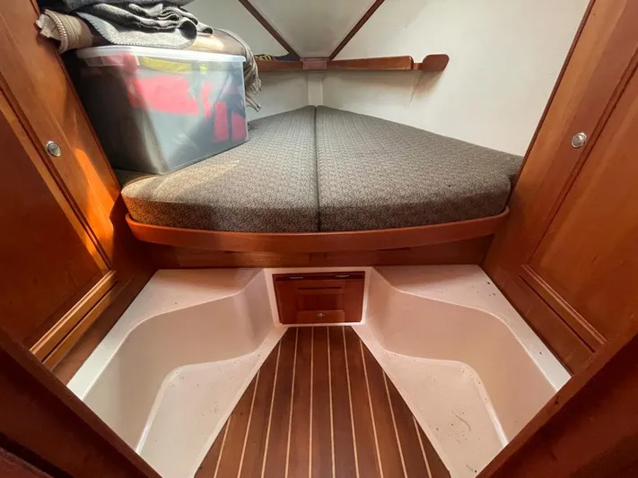 Bell Canto Yacht Photos Pics Cozy cabin interior of 2006 Tartan 3400 sailboat with wooden accents and storage.