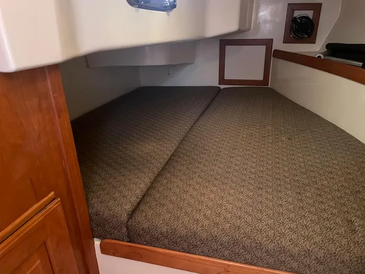 Bell Canto Yacht Photos Pics Interior cabin of 2006 Tartan 3400 sailboat with cushioned sleeping area.