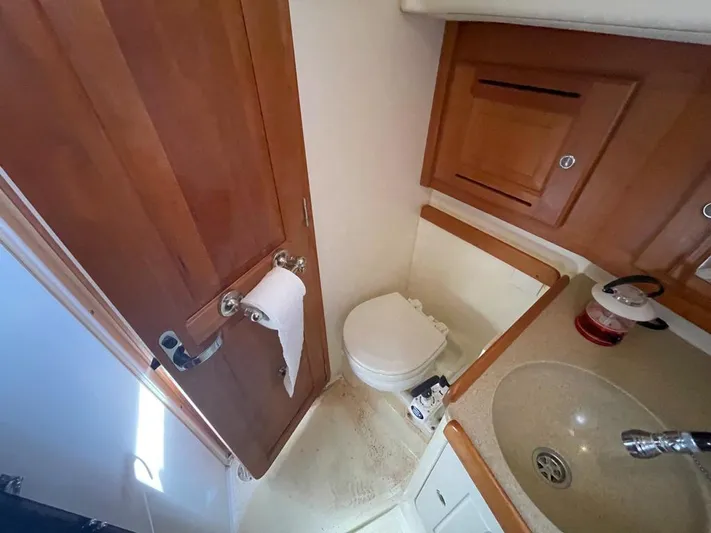 Bell Canto Yacht Photos Pics Compact bathroom in 2006 Tartan 3400 yacht with wooden door and sink.