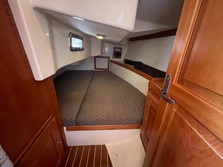 Bell Canto Yacht Photos Pics Cozy cabin interior of 2006 Tartan 3400 sailboat with wooden finishes.