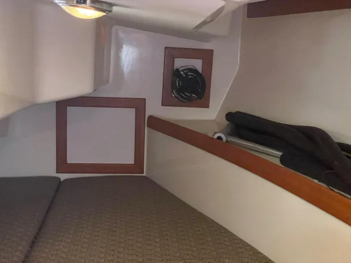 Bell Canto Yacht Photos Pics Cozy cabin interior of 2006 Tartan 3400 sailboat with cushioned seating and wooden accents.