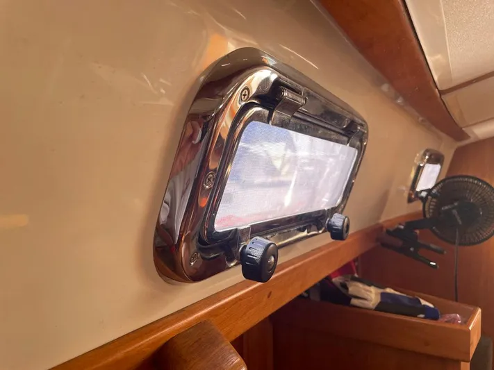 Bell Canto Yacht Photos Pics 2006 Tartan 3400 yacht interior with porthole and wooden trim.