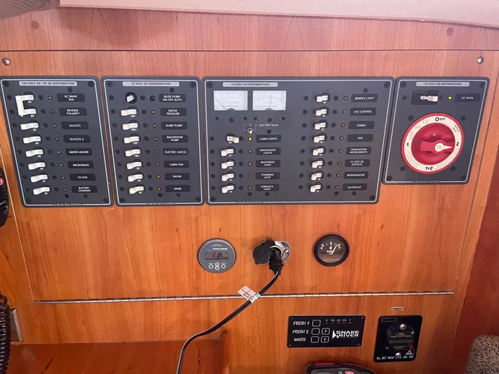 Bell Canto Yacht Photos Pics Electrical control panel on a 2006 Tartan 3400 sailboat, featuring switches and gauges.
