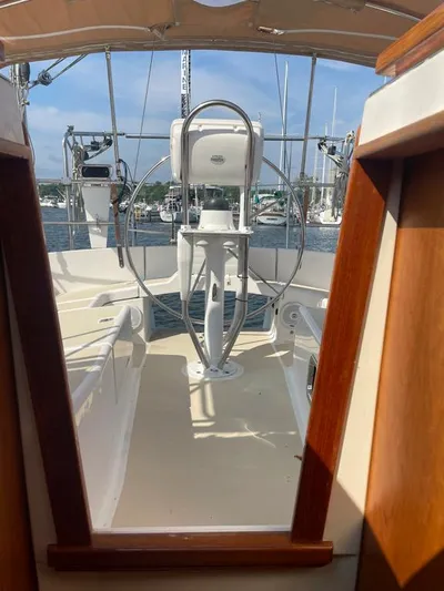 Bell Canto Yacht Photos Pics Tartan 3400 sailboat cockpit view, 2006 model, featuring steering wheel and open hatch.