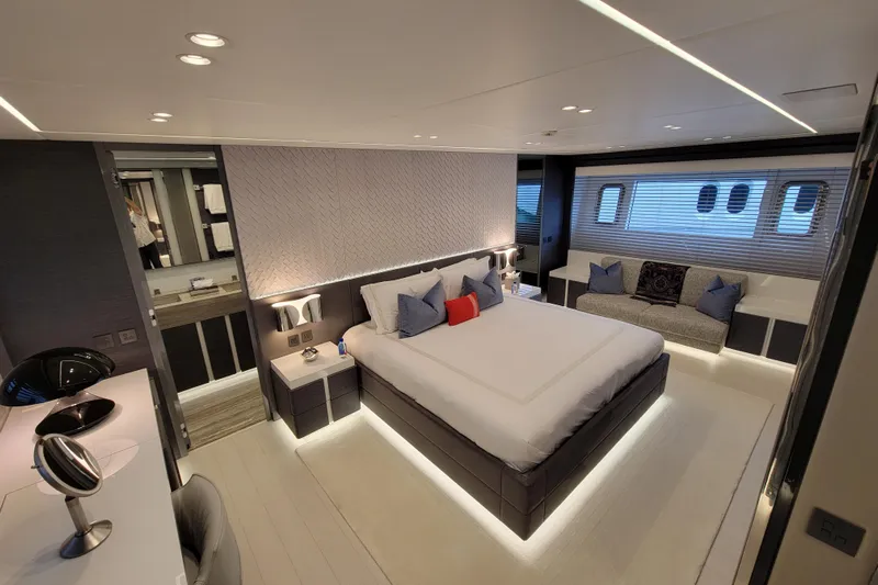 Nana I Yacht Photos Pics Luxurious bedroom interior of 2020 Mangusta 110 Open yacht, featuring modern design and elegant furnishings.