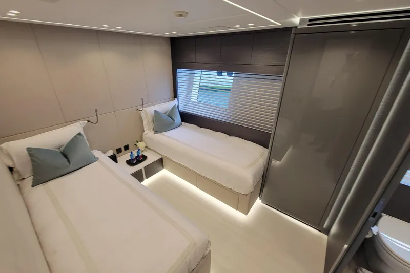 Nana I Yacht Photos Pics Luxurious twin bedroom in 2020 Mangusta 110 Open yacht, featuring modern design and ambient lighting.