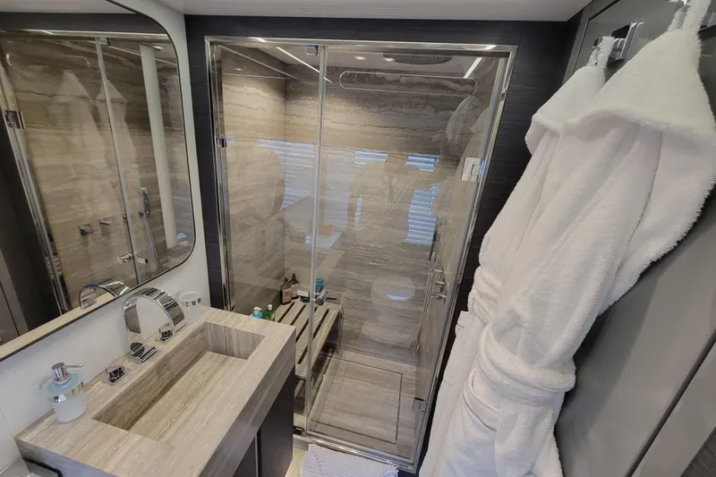 Nana I Yacht Photos Pics Luxurious bathroom in 2020 Mangusta 110 Open yacht with modern fixtures and plush robes.