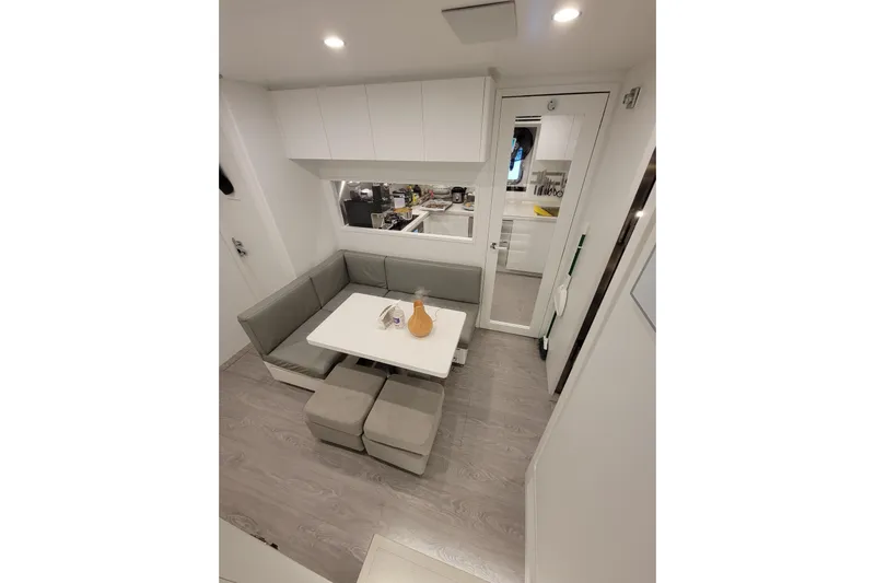 Nana I Yacht Photos Pics Luxurious interior of 2020 Mangusta 110 Open yacht with modern dining area and sleek design.