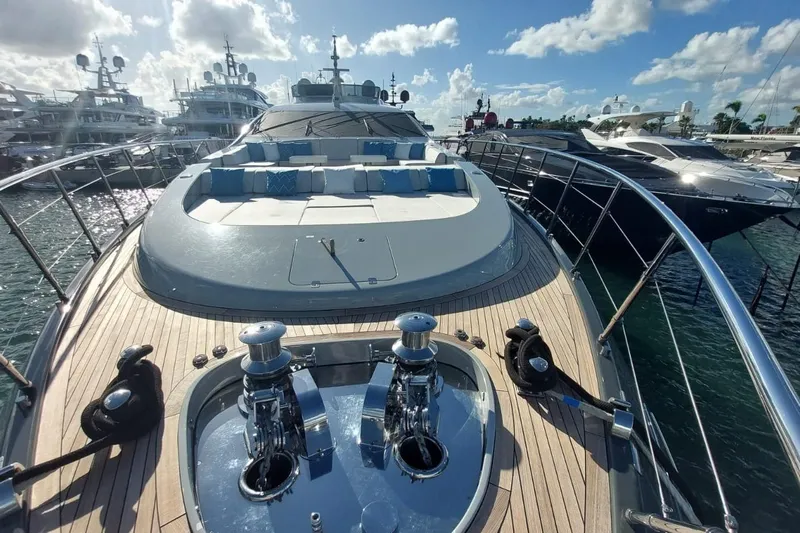 Nana I Yacht Photos Pics 2020 Mangusta 110 Open yacht with spacious deck and luxurious seating under a sunny sky.