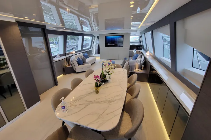 Nana I Yacht Photos Pics Luxurious interior of 2020 Mangusta 110 Open yacht with elegant dining area and modern decor.