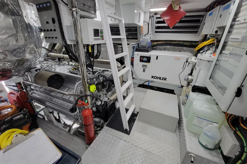 Nana I Yacht Photos Pics Engine room of 2020 Mangusta 110 Open yacht with Kohler generator and control panels.