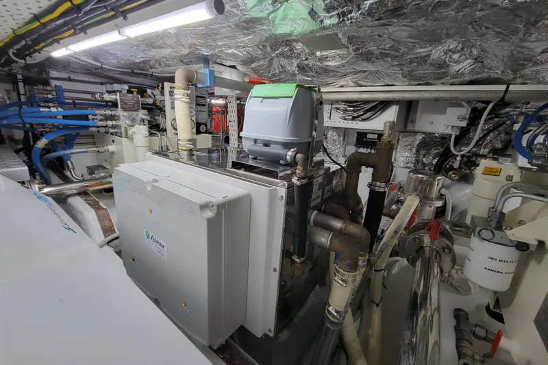 Nana I Yacht Photos Pics Engine room of 2020 Mangusta 110 Open yacht with complex machinery and piping.