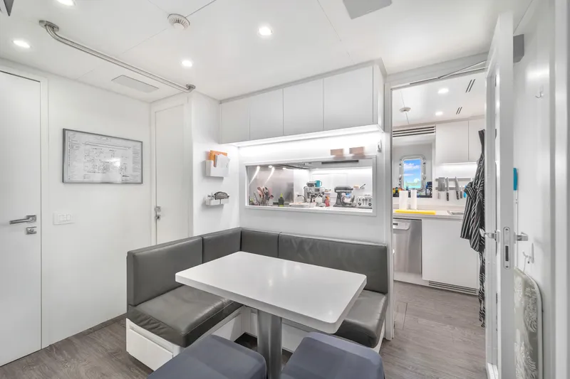 Nana I Yacht Photos Pics Modern interior of 2020 Mangusta 110 Open yacht with sleek dining area and kitchen.