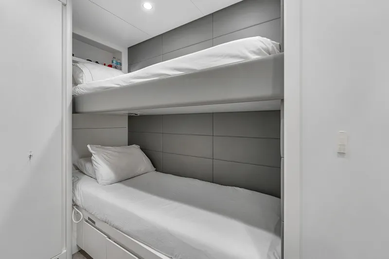 Nana I Yacht Photos Pics Bunk beds in a 2020 Mangusta 110 Open yacht cabin, featuring modern design and white bedding.