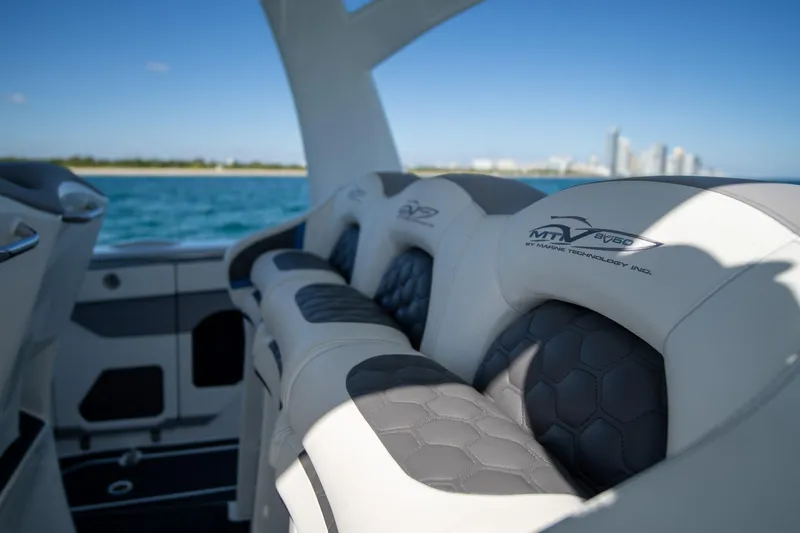  Yacht Photos Pics Luxury seating on 2023 MTI 50v boat with ocean and city skyline in background.