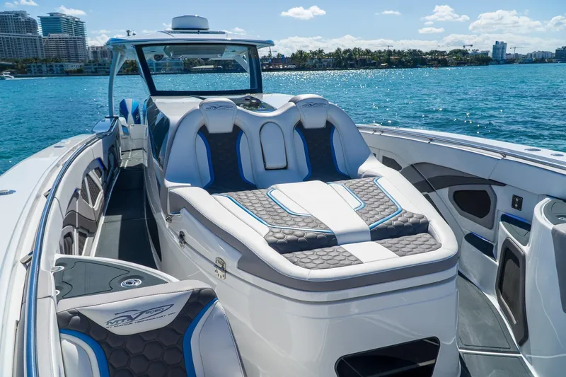  Yacht Photos Pics Luxurious 2023 MTI 50v boat interior with plush seating on a sunny day.