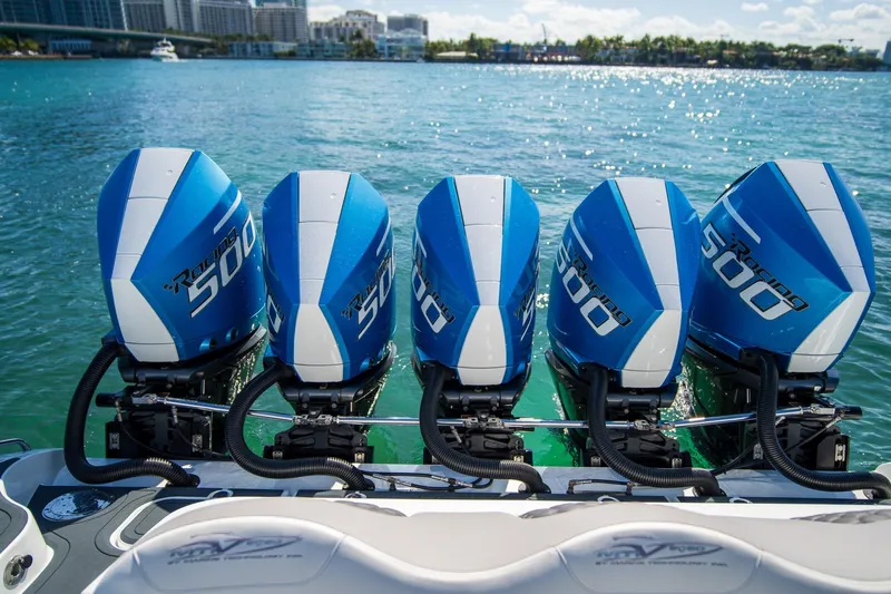  Yacht Photos Pics Five blue MTI 50v 2023 outboard motors on a boat in clear water.