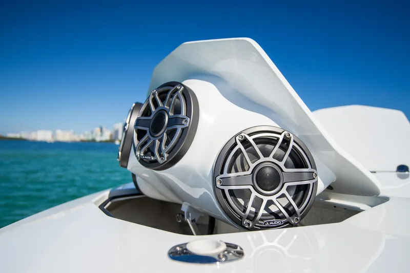  Yacht Photos Pics 2023 MTI 50v boat with JL Audio speakers, ocean backdrop, clear blue sky.