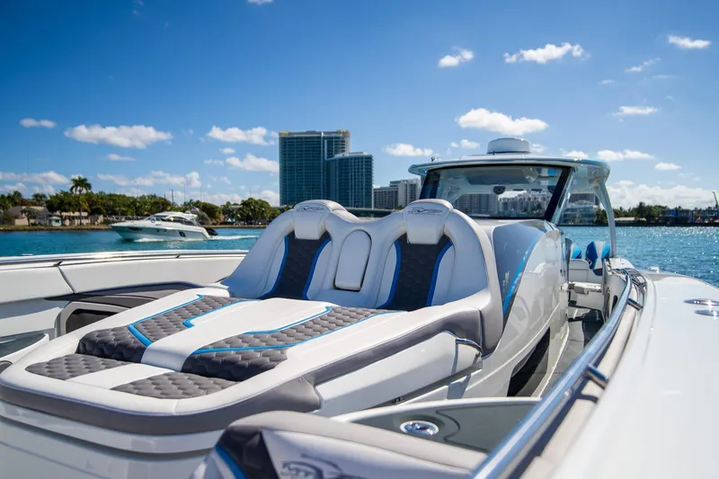  Yacht Photos Pics Luxury MTI 50v boat, 2023 model, with plush seating, cruising on a sunny day.