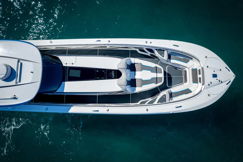 Yacht Photos Pics Aerial view of 2023 MTI 50v luxury boat on clear blue water.