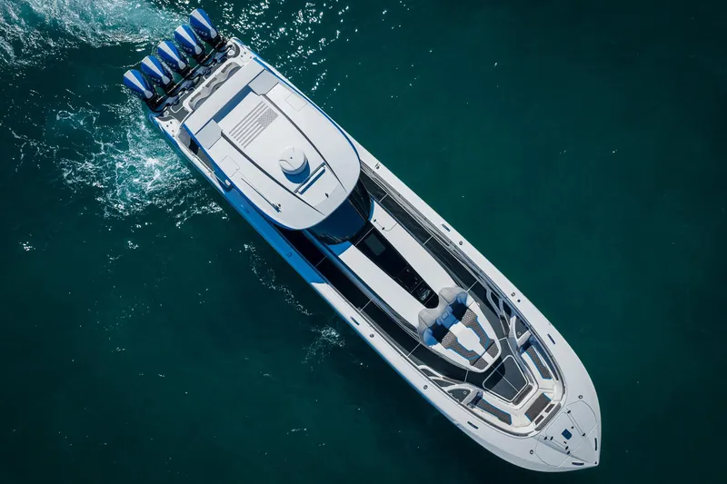  Yacht Photos Pics Aerial view of 2023 MTI 50v boat cruising on clear blue water.