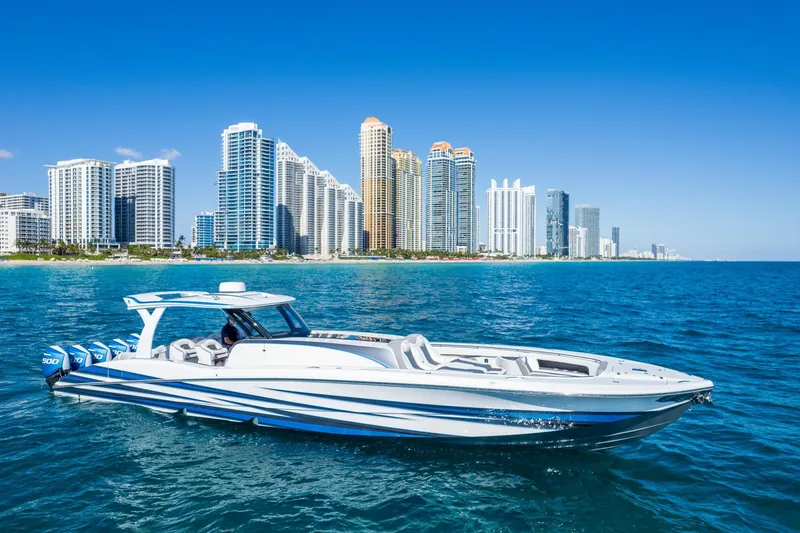  Yacht Photos Pics 2023 MTI 50v boat cruising near city skyline on a sunny day.