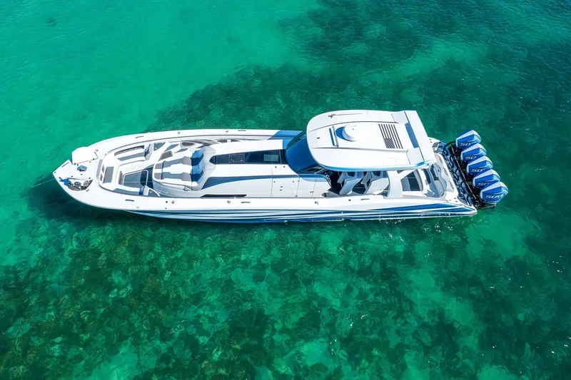  Yacht Photos Pics Aerial view of 2023 MTI 50v boat on clear turquoise water.