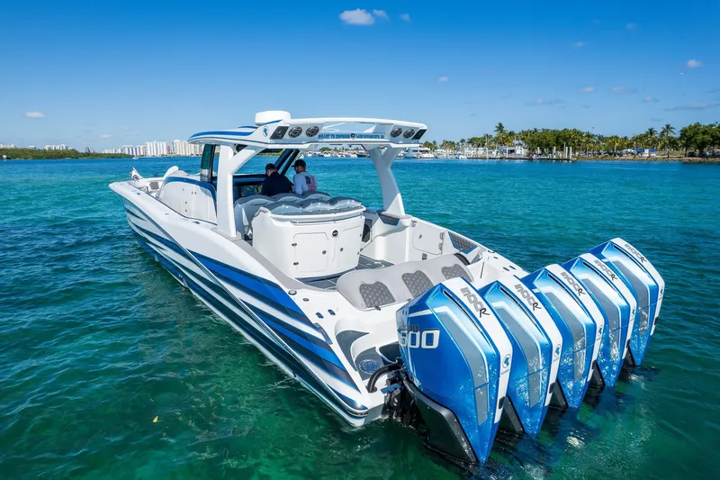  Yacht Photos Pics 2023 MTI 50v boat with five powerful outboard engines on clear blue water.