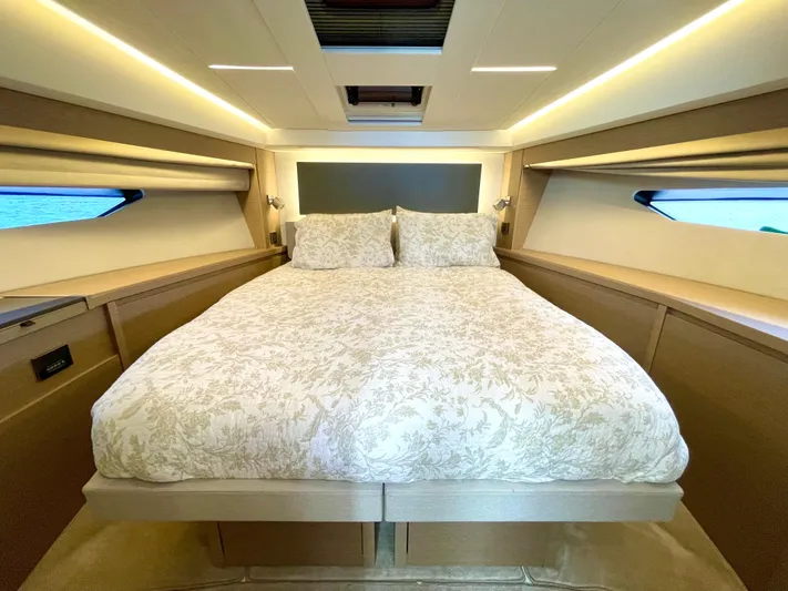 M.y. Blu Dayz Yacht Photos Pics Luxurious bedroom interior of 2023 Prestige 520 yacht with elegant bedding and ambient lighting.