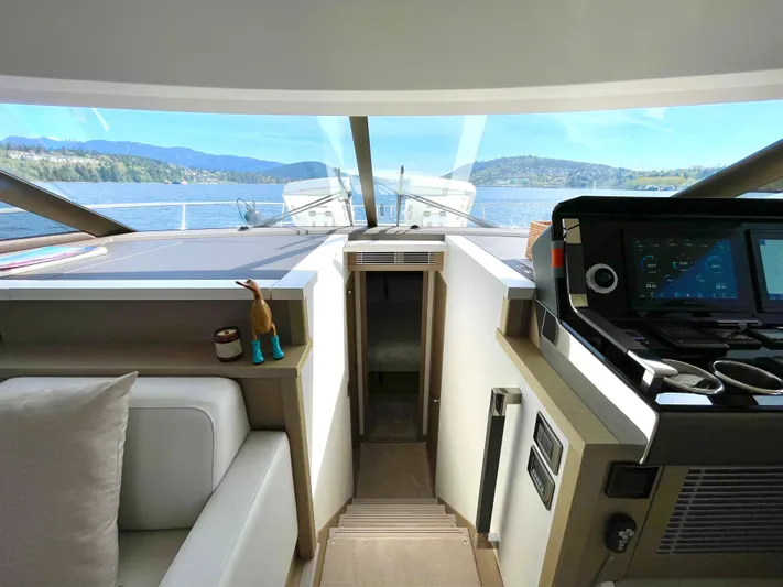 M.y. Blu Dayz Yacht Photos Pics Interior view of 2023 Prestige 520 yacht with scenic water and mountain backdrop.