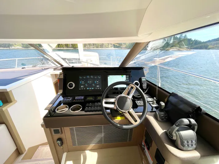 M.y. Blu Dayz Yacht Photos Pics Cockpit of 2023 Prestige 520 yacht with modern controls and scenic water view.