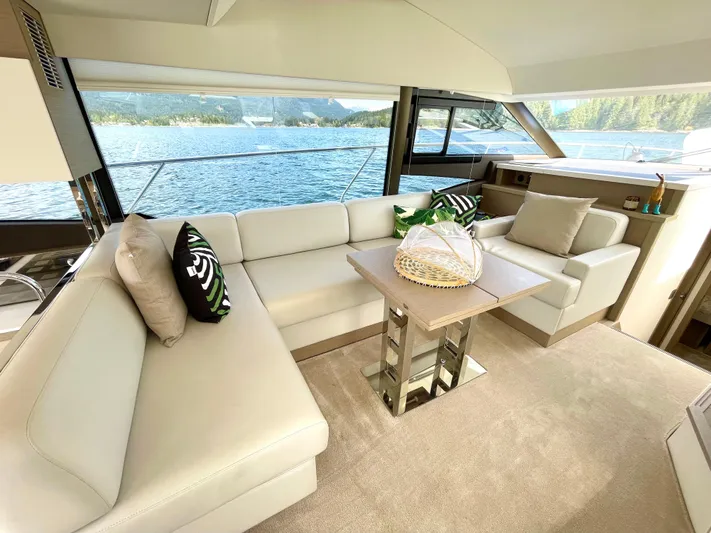 M.y. Blu Dayz Yacht Photos Pics Luxurious interior of 2023 Prestige 520 yacht with elegant seating and scenic water view.