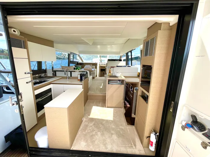 M.y. Blu Dayz Yacht Photos Pics Luxurious interior of 2023 Prestige 520 yacht with modern kitchen and panoramic windows.