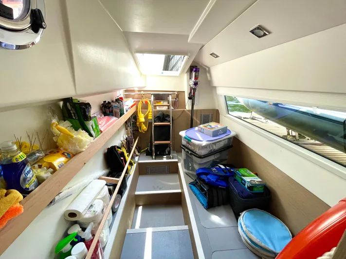 M.y. Blu Dayz Yacht Photos Pics 2023 Prestige 520 yacht interior storage area with shelves and supplies.