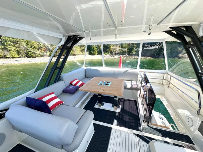 M.y. Blu Dayz Yacht Photos Pics Luxurious 2023 Prestige 520 yacht interior with comfortable seating and scenic water view.