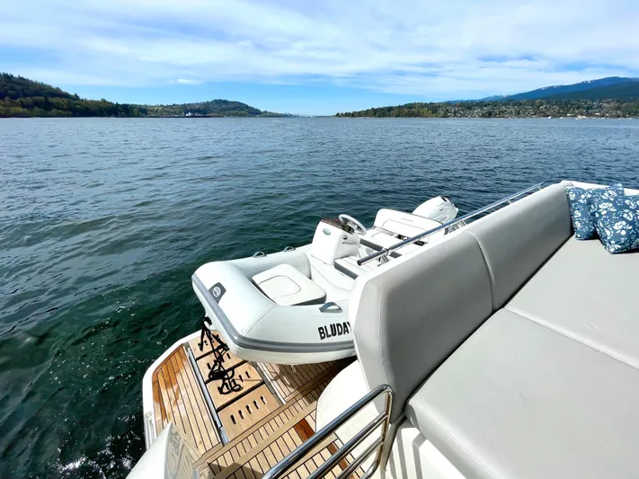 M.y. Blu Dayz Yacht Photos Pics Luxurious 2023 Prestige 520 yacht with tender on scenic lake.