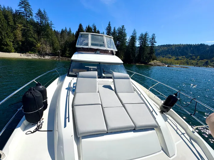 M.y. Blu Dayz Yacht Photos Pics Prestige 520 yacht on serene lake with forested shoreline, 2023 model.