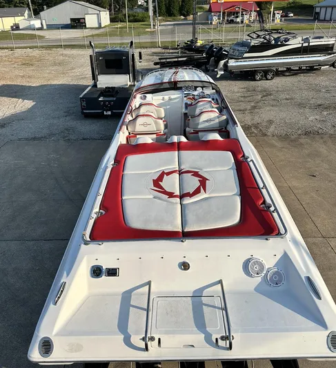  Yacht Photos Pics 2007 Fountain 47 Lightning speedboat with red and white seating, parked on a concrete surface.
