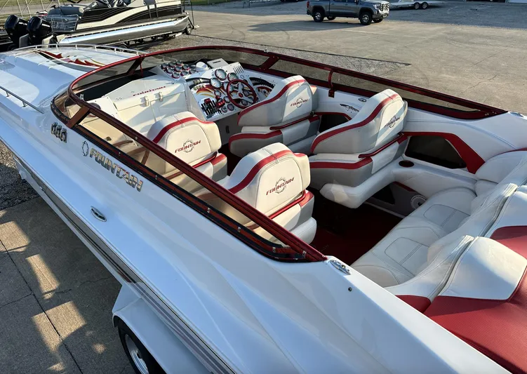  Yacht Photos Pics 2007 Fountain 47 Lightning boat with white and red interior, docked on a sunny day.