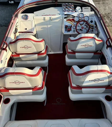  Yacht Photos Pics 2007 Fountain 47 Lightning boat interior with red and white seating and detailed dashboard.